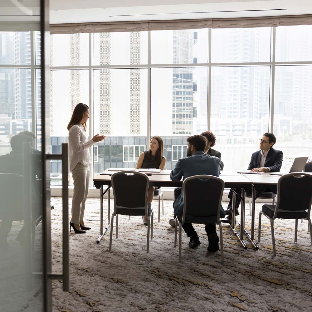 Wide shot of business team talking at meeting table